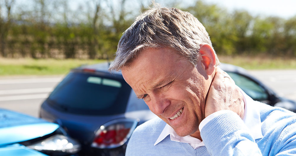 Driver Suffering From Whiplash After Traffic Collision