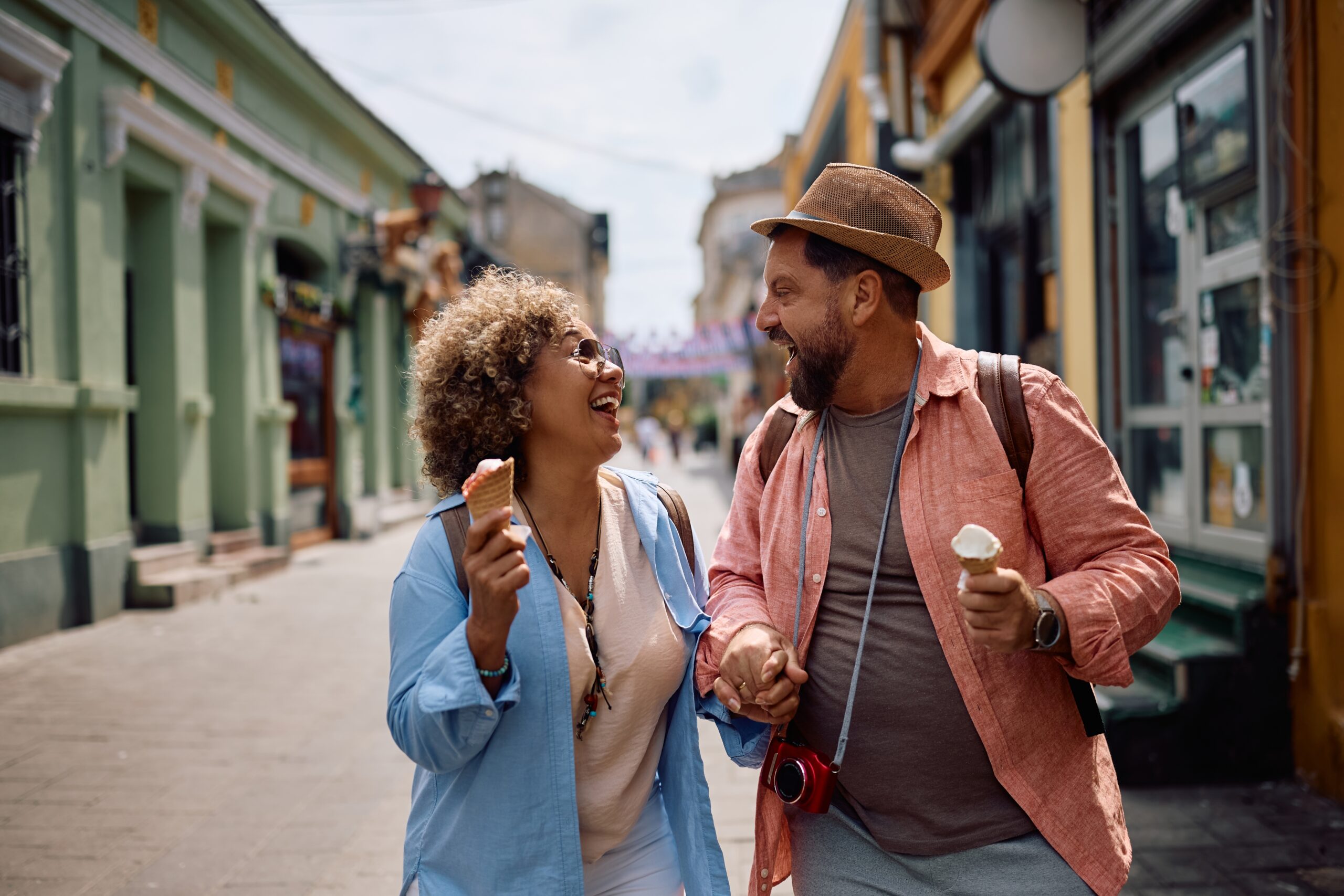 Cheerful,Couple,Of,Tourists,Laughing,And,Eating,Ice,Cream,While